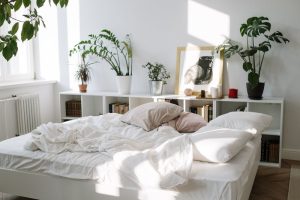 Soft white adjustable pillows stacked on a bed