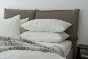White adjustable pillows arranged on a clean bed