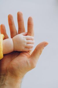 Mother using a nursing pillow to support baby during feeding