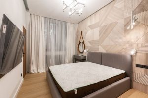 Orthopaedic pillow arranged on comfortable bed