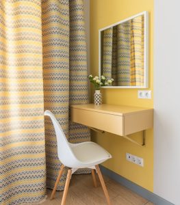 Round knitted pouf used as a footrest in a modern room