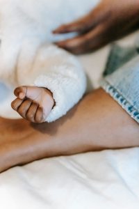 Large pregnancy support pillow on a bed